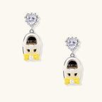 Drop earrings featuring miniature translucent handbag charms with heart crystal studs, silver bow accents, and pearls