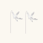 Delicate sterling silver dragonfly earrings with textured wings and curved threader hooks on white background