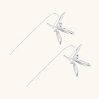 Delicate sterling silver dragonfly earrings with textured wings and curved threader hooks on white background