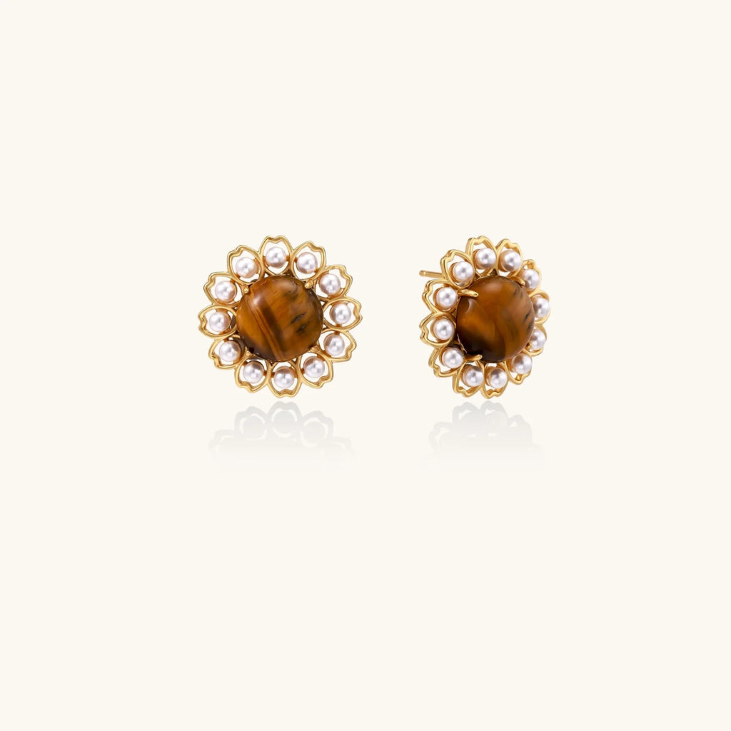 Gold-plated stud earrings with cushion-cut tiger's eye stones surrounded by pearl halos on white background.