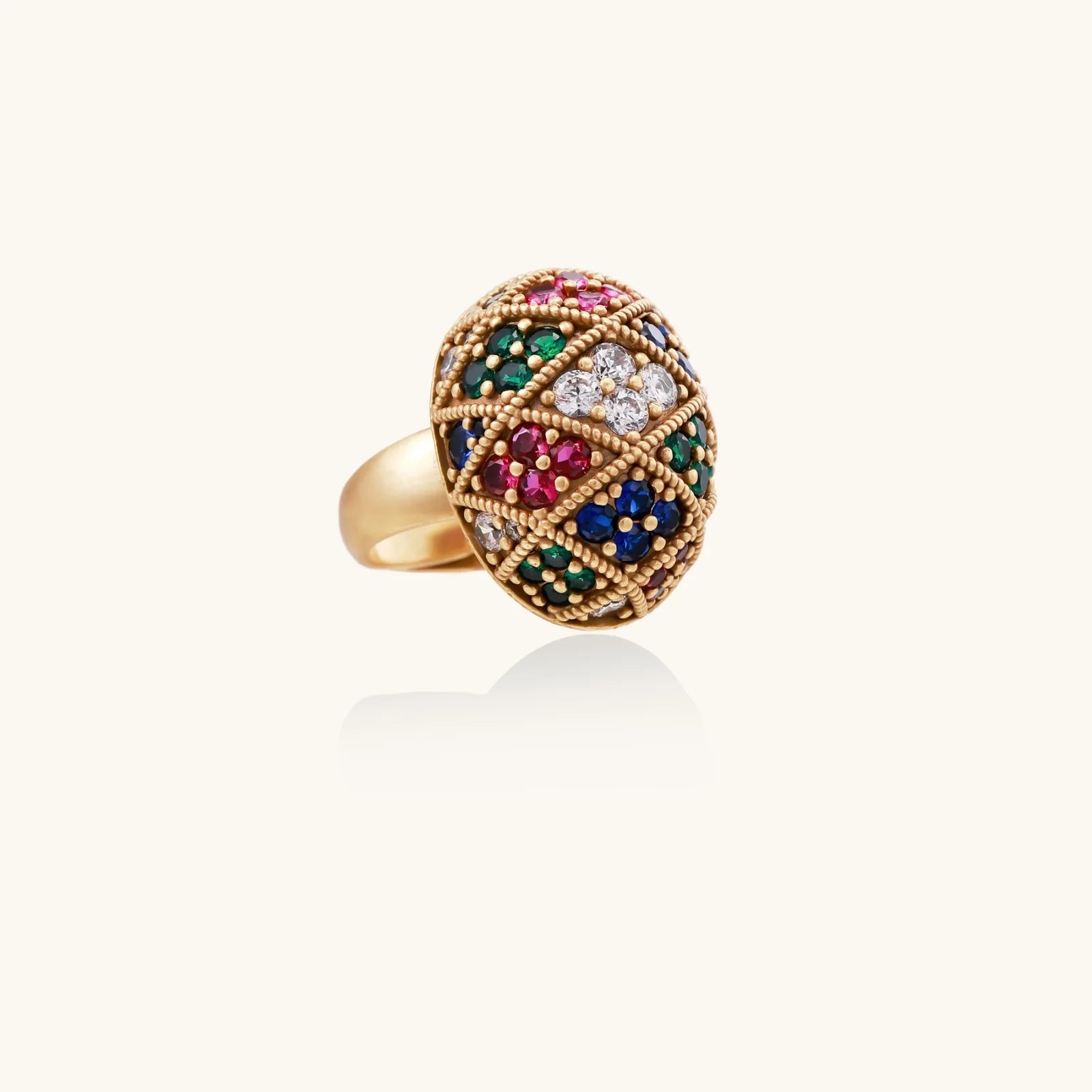 Oversized gold ring with geometric mosaic pattern featuring multicolor zirconia stones in ruby, emerald, sapphire, and clear tones.