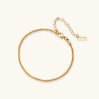 Delicate 18K gold-plated stainless steel bracelet with textured beaded chain on cream background