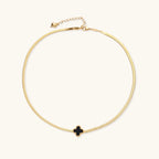 Dainty 18K gold-plated herringbone chain necklace with black enamel quatrefoil clover pendant on white background