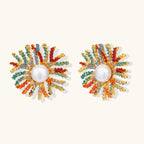 Vibrant starburst stud earrings with multicolor enamel rays and white pearl centers on gold-plated setting