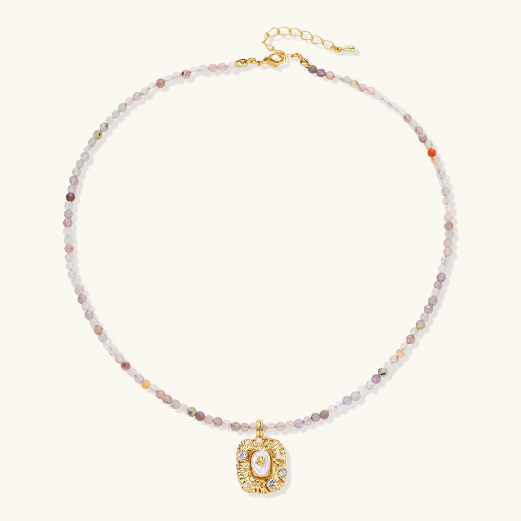 Ornate gold-plated pendant necklace with multicolored gemstone beads in purple, pink and clear tones on white background