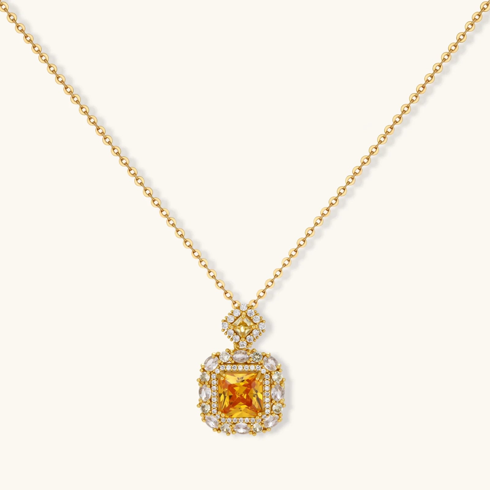 14K gold-plated jewelry set featuring square-cut cubic zirconia stones in ornate layered settings on white background.