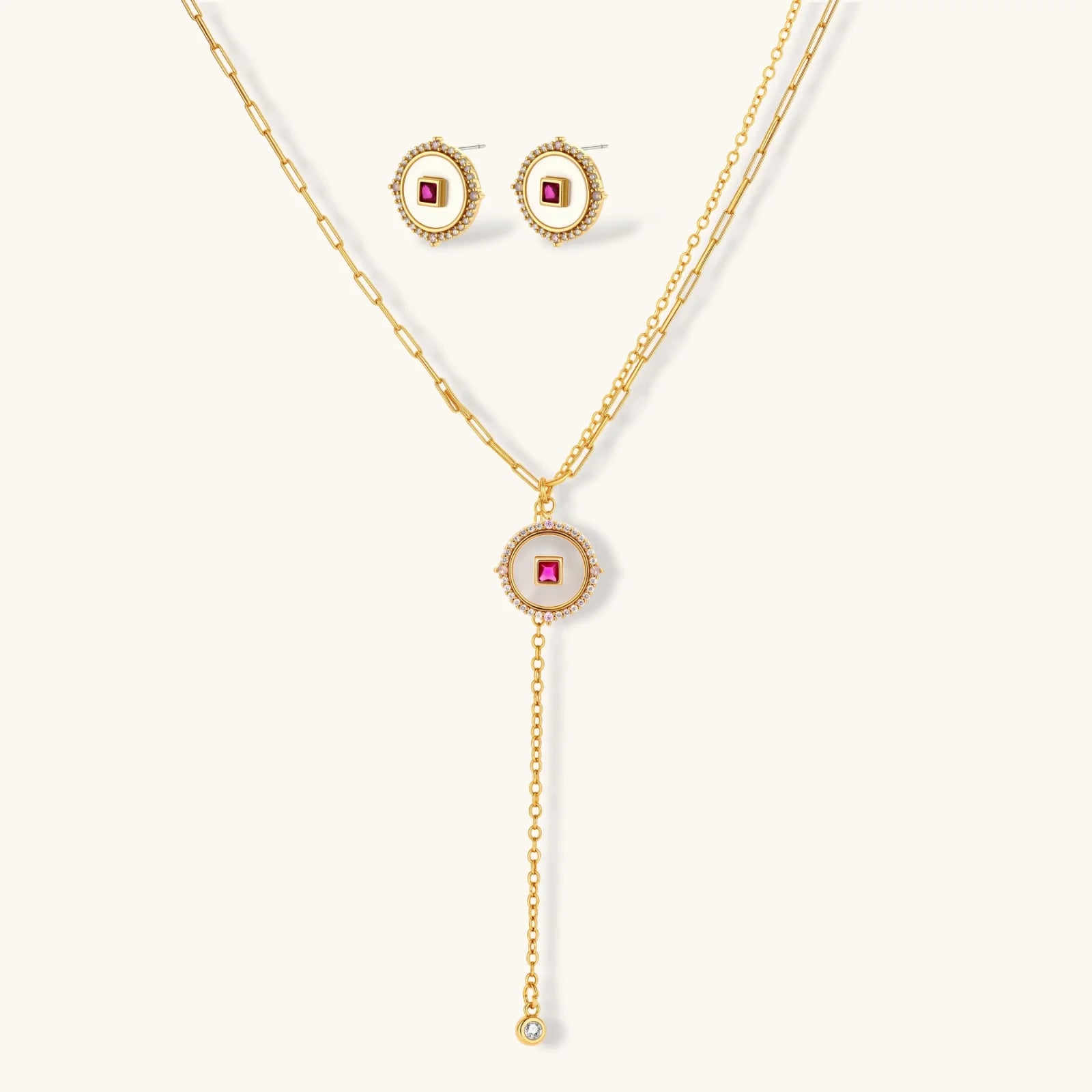 Gold-plated circular medallion necklace set with white enamel base and pink cubic zirconia accent stones