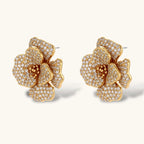 14K gold-plated floral jewelry set with blue cubic zirconia centers and pearl chain details on white background.