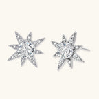 Sterling silver star-shaped stud earrings with brilliant moissanite center stones and pavé details on neutral background.