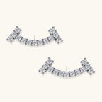 Curved sterling silver ear climbers with moissanite stones arranged in elegant arc shape on white background