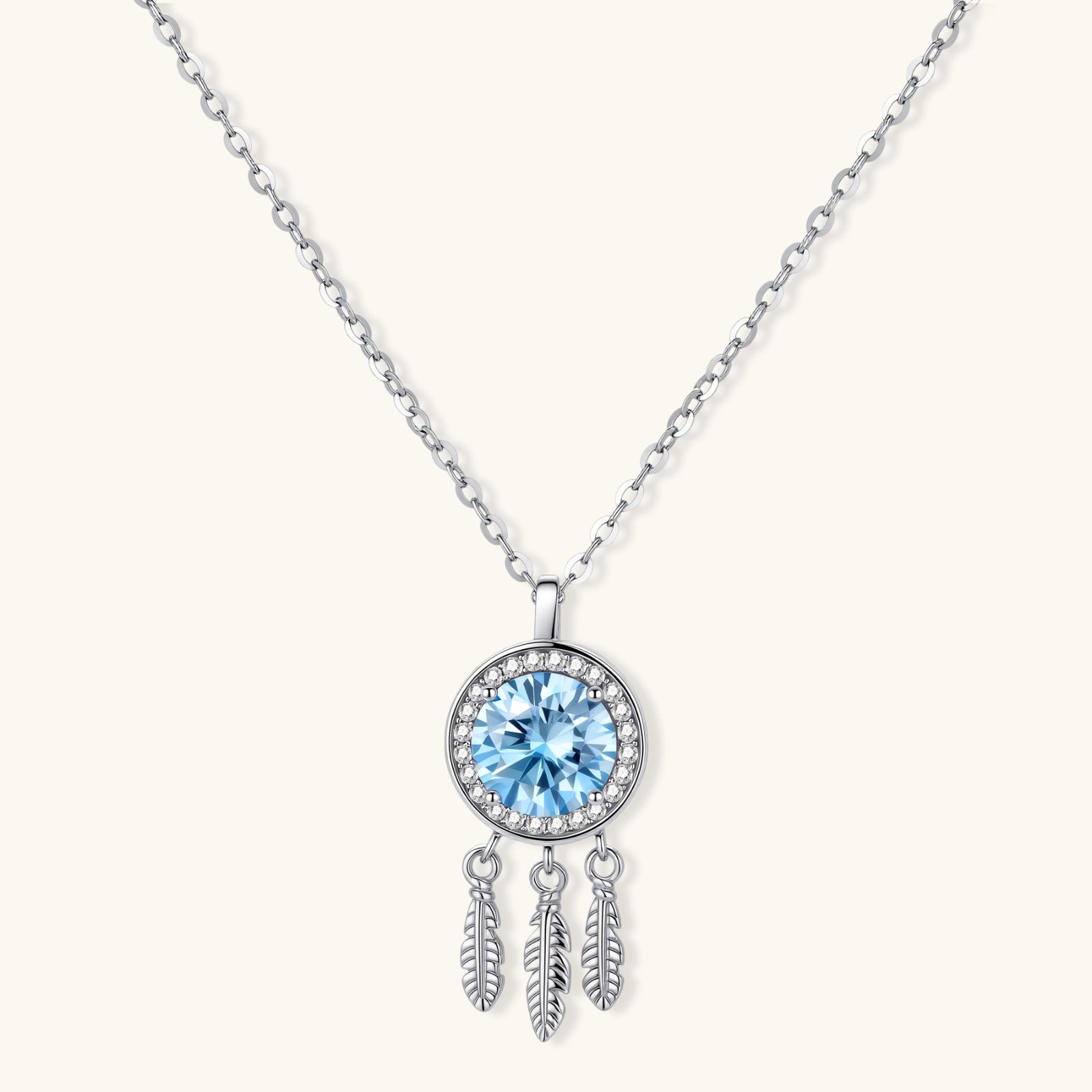 Sterling silver dreamcatcher pendant with blue moissanite center and three feather charms on adjustable chain.