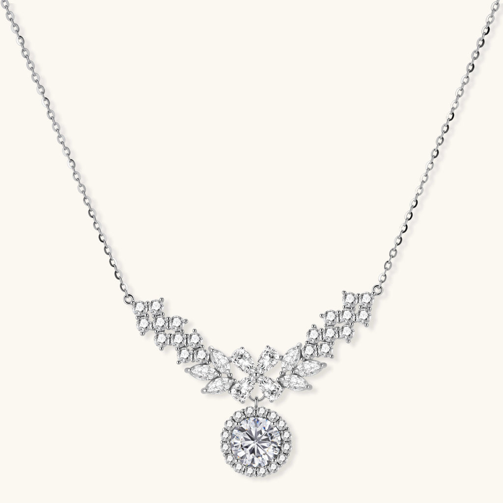 Elegant sterling silver necklace featuring intricate wing-like design with brilliant moissanite stones on neutral background.