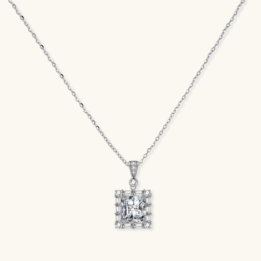 Square moissanite pendant with halo setting on delicate sterling silver chain against white background.