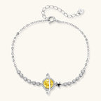 Sterling silver bracelet with yellow moissanite centerpiece in oval setting, crystal chain, and star charm on white background.