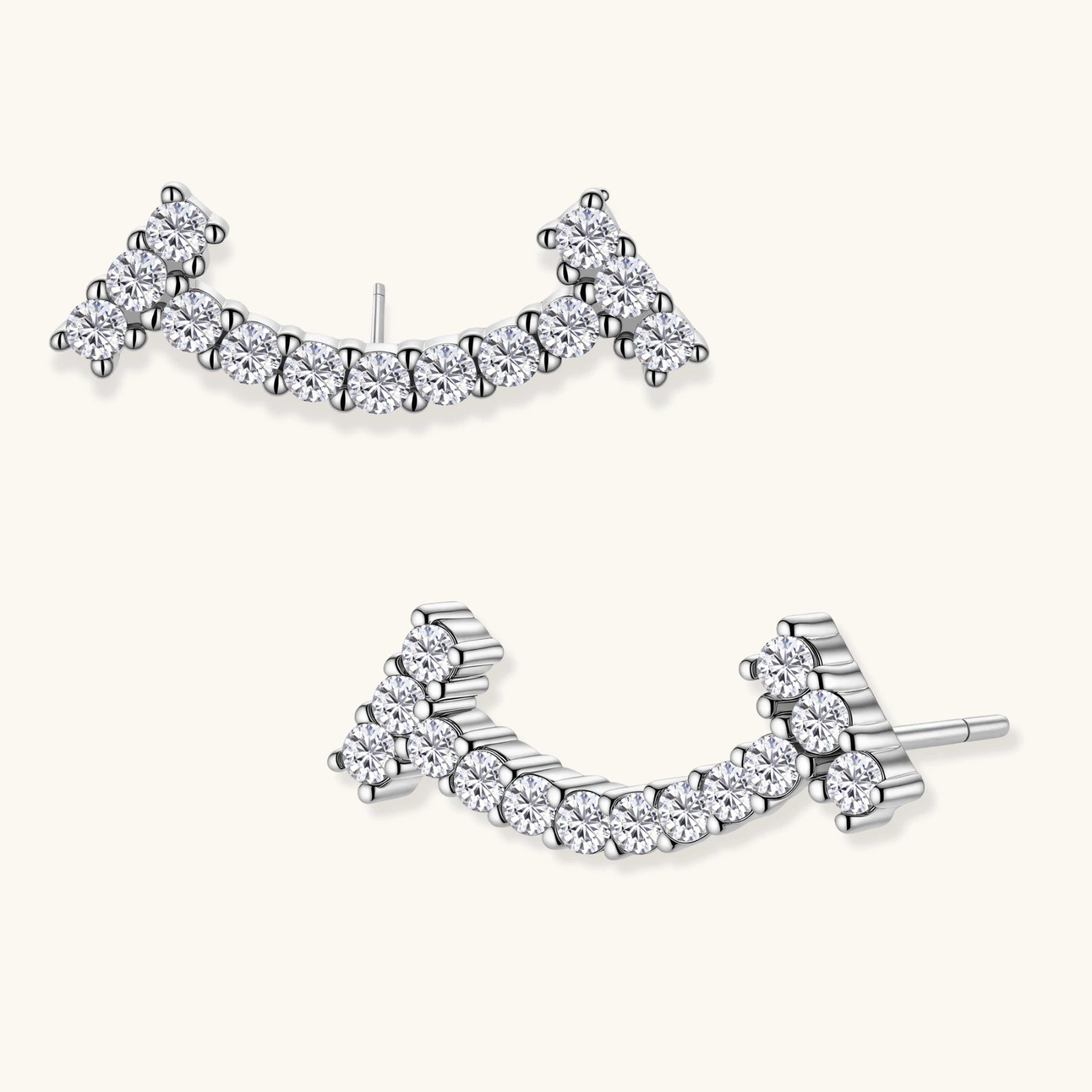 Curved sterling silver ear climbers with moissanite stones arranged in elegant arc shape on white background