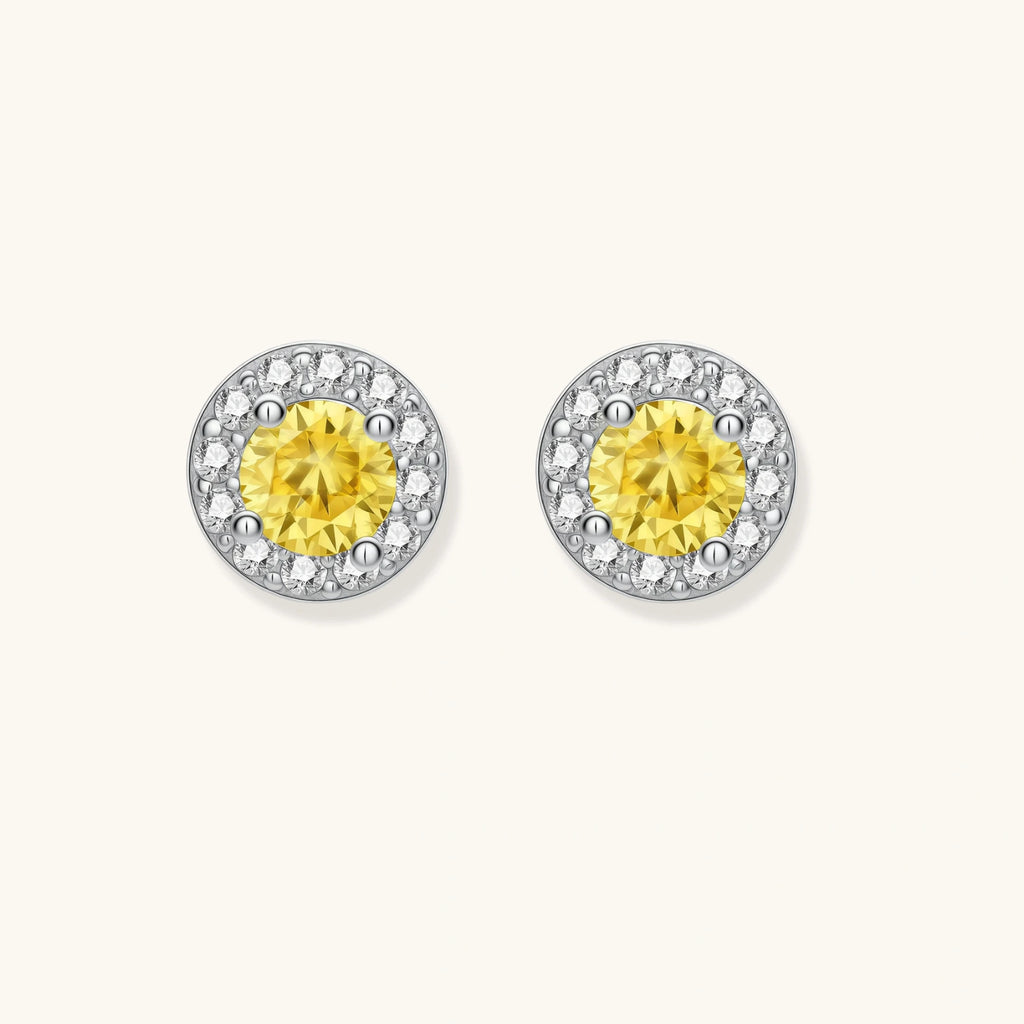 Dainty sterling silver stud earrings with yellow moissanite center stones surrounded by white halo stones