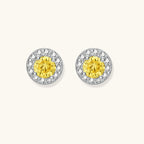 Dainty sterling silver stud earrings with yellow moissanite center stones surrounded by white halo stones