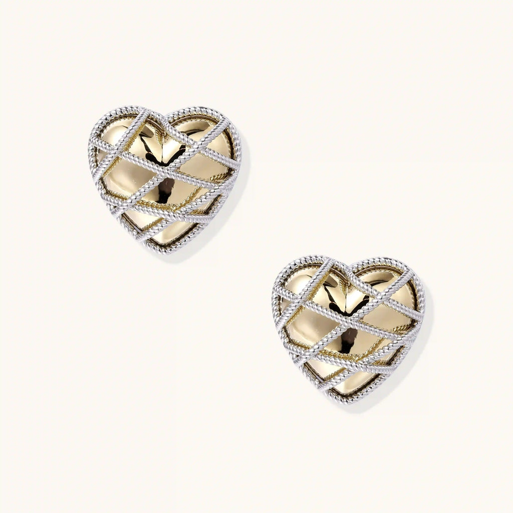 Heart-shaped stud earrings with intricate lattice design in 18K gold plated brass and silver-tone metal.
