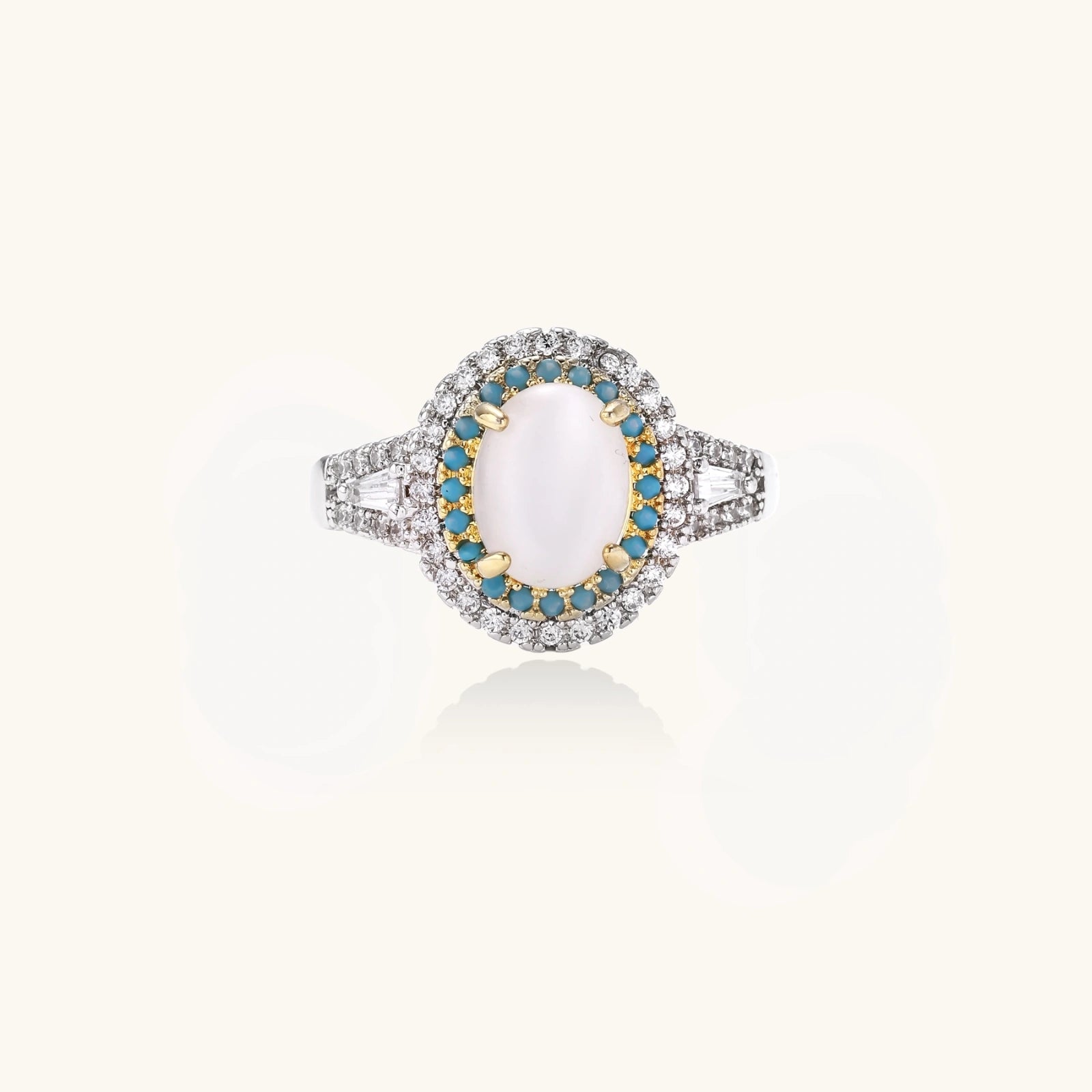 Vintage-style cocktail ring with luminous cat's eye center stone surrounded by turquoise and crystal double halo on white gold plated band